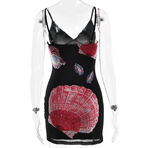 Detail of black mini dress with vibrant red and blue shell prints on breathable mesh fabric
