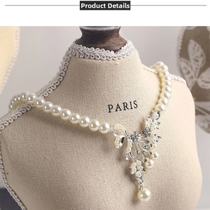 Close-up of pearl necklace with a rhinestone butterfly pendant on a Paris mannequin
