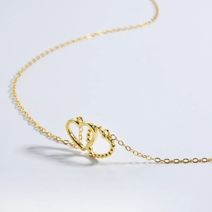 Elegant gold S925 silver necklace featuring an interlocking double heart pendant on a white background