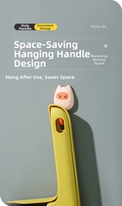 Detail of cleaning brush handle with hole and pink cat-ear wall hook for storage