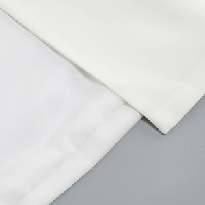 Close-up of white professional suit fabric showing fine texture and stitching details