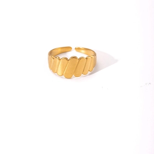 Detail view of a gold-plated adjustable wave texture ring with a metallic glossy finish