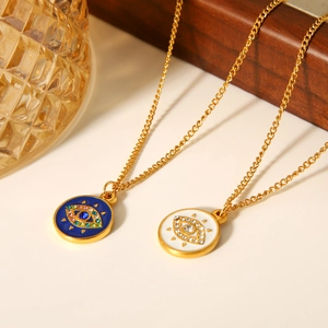 Macro detail of gold necklaces featuring blue and white enamel evil eye pendants with gems
