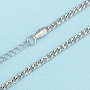 Macro shot of silver stainless steel Cuban chain links with adjustable extension link