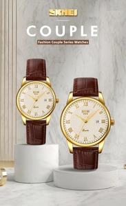 Classic leather couple watches with golden case and Roman numeral date dial on marble