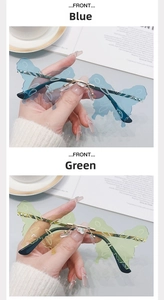 Detail of rimless butterfly sunglasses with blue and green lenses and heart crystal accent