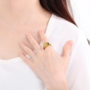 Polished 18K gold-plated stainless steel signet ring shown on model's finger