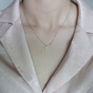 Classic S925 sterling silver cross necklace with sparkling diamonds worn by a model