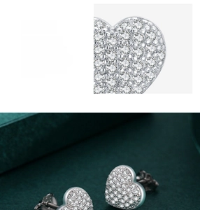 Macro detail of S925 sterling silver heart earrings with pave-set white cubic zirconia