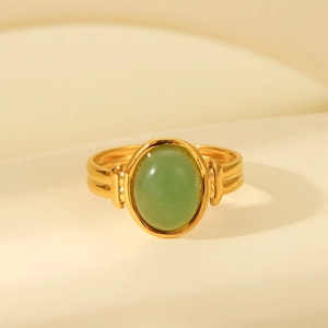 Close-up of vintage 18K gold plated ring with a large oval green gemstone inlay