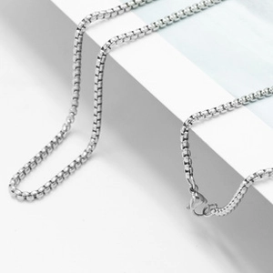 Detail shot of silver stainless steel snake chain showing high-shine and lobster clasp