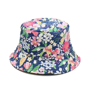 Floral reversible bucket hat with pink and yellow flower patterns on dark blue background