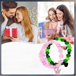 Detail of pink and green beaded bracelets with crown charm and heart magnetic clasp