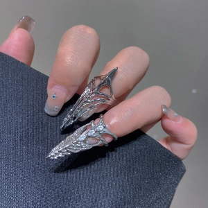 Detail of silver liquid metal gothic nail rings with cubic zirconia on model's fingertips