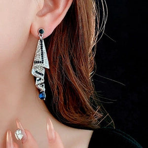 Elegant geometric drop earrings with blue and white crystals on a silver-tone base