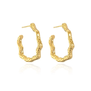 Detail showing the irregular wave texture and hammered gold finish of C-shaped hoop earrings
