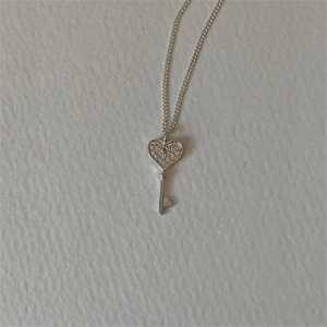 S925 sterling silver heart key pendant necklace with shimmering zircon stones flat lay view