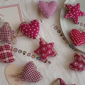 Handmade Christmas heart and star fabric ornaments with rustic stitching and hanging hemp rope