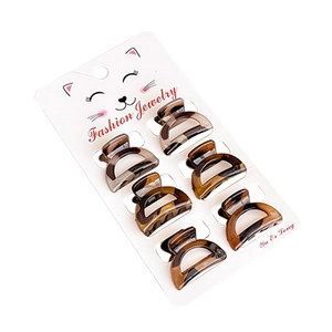 Set of 8 leopard print mini claw clips for hair on a white cat-patterned card display
