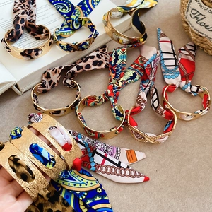 French vintage gold open cuff bracelet with elegant silk scarf wrap in assorted patterns