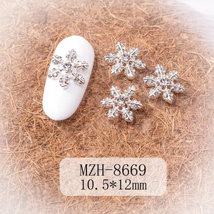 Macro view of 10.5x12mm silver snowflake alloy nail charms with rhinestones