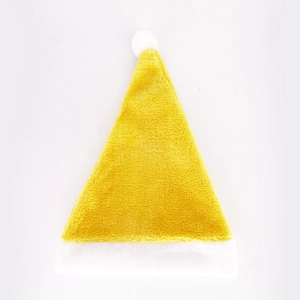 Detail of yellow and white plush Christmas hat made of soft velvet material