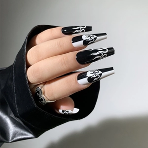 Macro detail of long coffin nails with black and white flame and heart marble art designs