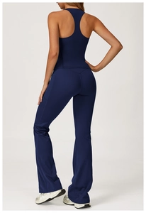 Detail view of dark blue racerback tank top and high-waisted flared yoga leggings for women