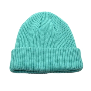 Detail view of mint green ribbed knit beanie showing thick wool texture and folded cuff
