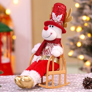 Detailed view of a plush Christmas reindeer doll sitting on a miniature rocking chair