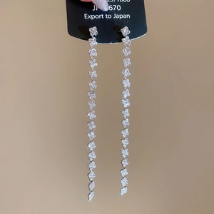 Detailed view of silver long fringe tassel earrings with shimmering cubic zirconia accents