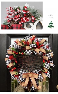 Detail of Christmas wreath with buffalo plaid bow, red berries and pine cones on a door