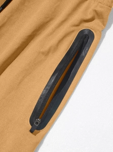 Detail of khaki fitness pants showing high-quality fabric texture and waterproof zipper