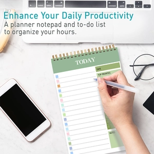 Green spiral daily planner on marble desk showing task list and time management sections