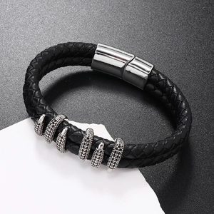 Macro view of black braided leather bracelet with silver claw beads and magnetic clasp