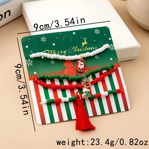 Detailed view of four-piece Christmas beaded bracelet set with festive metal charms