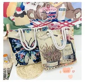 Detail of canvas tote bags with blue butterfly and lavender floral patterns