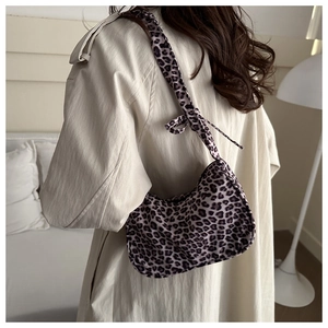 Close-up of leopard print shoulder bag fabric and pleated texture on tote bag