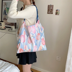 Floral print tote bag detail featuring tulip patterns and blue rope shoulder strap