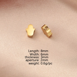 Detailed view of 8x6mm gold Hamsa Hand charms with specific measurements and weight