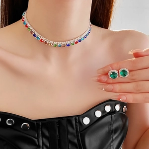 Close-up of elegant gradient colorful rhinestone necklace and green stud earrings set