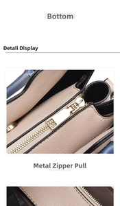 Detail view of smooth golden zipper and tricolor patchwork on lychee grain leather handbag