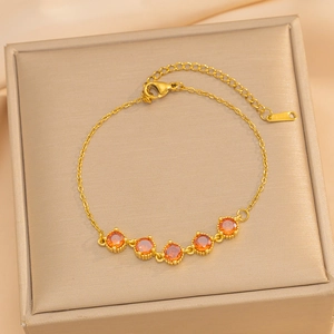 18K gold-plated bracelet with five orange garnets on elegant silk background decor