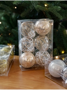 Detail of 6cm transparent and white grid Christmas ornaments with festive warm lighting