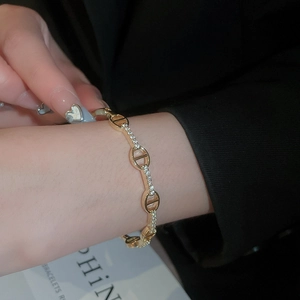 Close-up of a gold-plated oval link bracelet with shimmering pavé set cubic zirconia