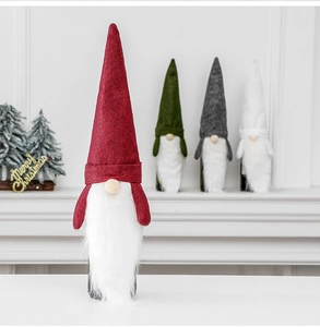 Detail of Christmas gnome wine bottle covers in red, green and grey felt on a mantel