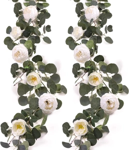 Detailed view of artificial eucalyptus garland with white peonies for wedding decor