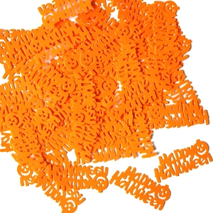 Flat lay of orange Happy Halloween confetti with pumpkin shapes for party decor