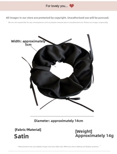 Detail view of black satin bow scrunchie showing 14cm diameter and fabric texture
