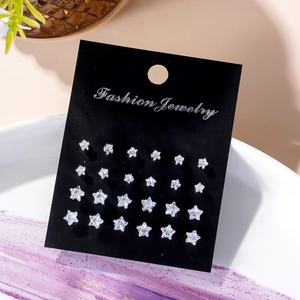 Set of 12 pairs of star-shaped zircon stud earrings in various sizes on a black display card